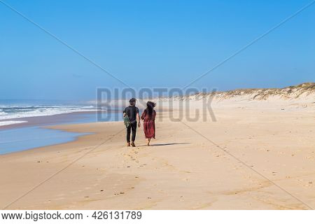 Sao Martinho do Porto, Portugal - July 2, 2021: Couple at the  beach near Sao Martinho do Porto, Portugal