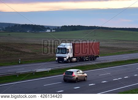 Semi Truck Transport The Sea Container On Highway. Shipping Containers Delivery, Maritime Services A