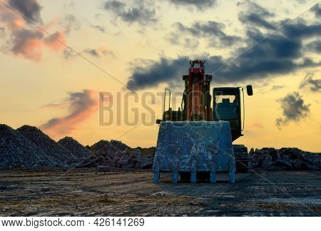 Recycling Concrete And Construction Waste From Demolition. Excavator At Landfill Of The Disposa. Reu