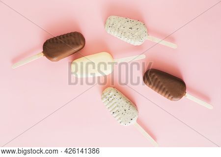Flat Lay Of Difference Chocolate Popsicles On Pastel Background