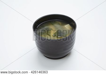 Miso Soup With Seafood In A Black Karelka On White Background.