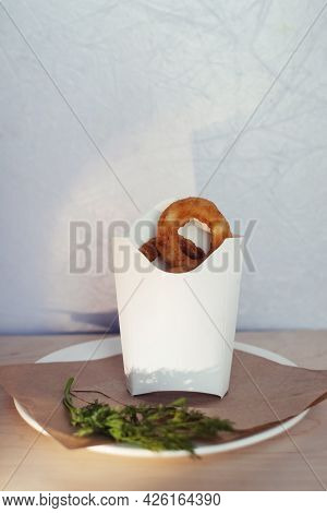 Close-up Of Onion Rings In Batter. Fried Vegetables At A Fast Food Restaurant. Vegetarian Cuisine In