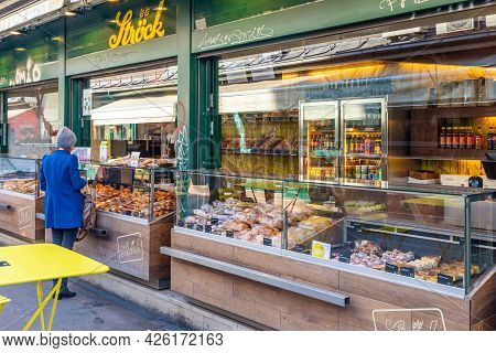 Vienna, Austria - 7 April 2015 - A Woman Stops To Buy Food At A Bakery Shop In Vienna, Austria On Ap