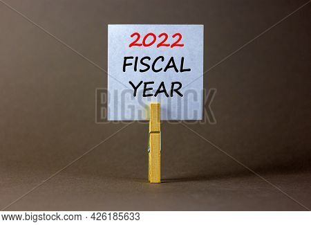 2022 Fiscal New Year Symbol. White Paper With Words '2022 Fiscal Year', Clip On Wooden Clothespin. B