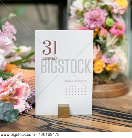 Card mockup by bouquet of flowers on a wooden table