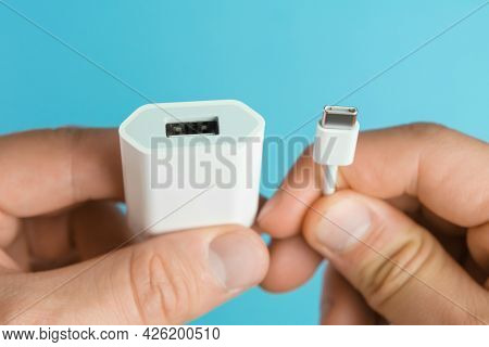 Usb Type C Cable And Usb Type A Adapter Plug In Mans Hands On The Blue Background