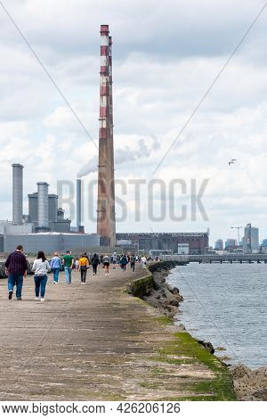 People Walk On Hte Great South Walk At Pollbeg Lighthouse.