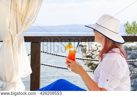 Work From Anywhere. Young Smilyng Woman, Female Freelancer In Straw Hat Working On Laptop On Beach.