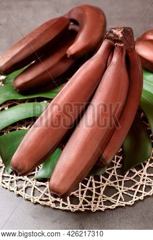 Tasty Red Baby Bananas On Grey Table
