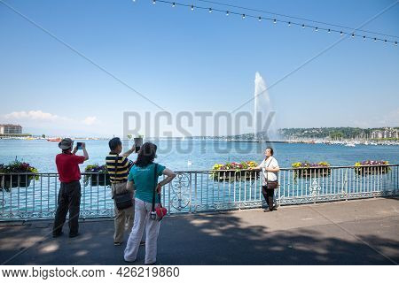 Geneva, Switzerland - June 19, 2017: Group Of Asian Tourists From China Taking Pictures And Smiling 