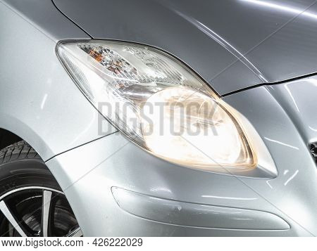Novosibirsk, Russia - June 29, 2021: Toyota Vitz, Shiny Glass Car Headlight With Glare From Lighting