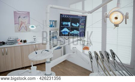 Empty Stomatology Orthodontic Office Room Equipped With Professional Dentistry Tools Ready For Medic
