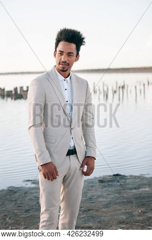 Young Black Man In Nature Posing With A Convertible. Looking Into The Distance