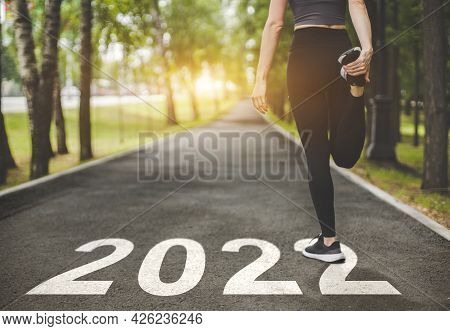 Female Feet In Sneakers At The Start. Beginning And Start Of The New Year 2022, Goals And Plans For 