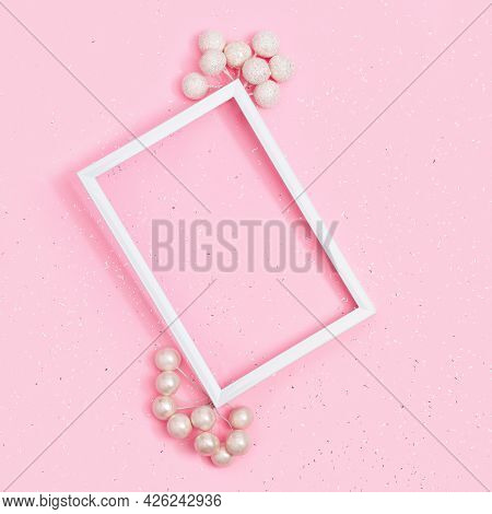 Birthday Or Holiday Mockup With Frame,on Pink Paper Background Covered With Sequins With Copy Space.