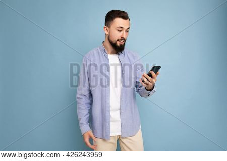 Handsome Young Brunette Unshaven Man With Beard Wearing Stylish White T-shirt And Blue Shirt Isolate