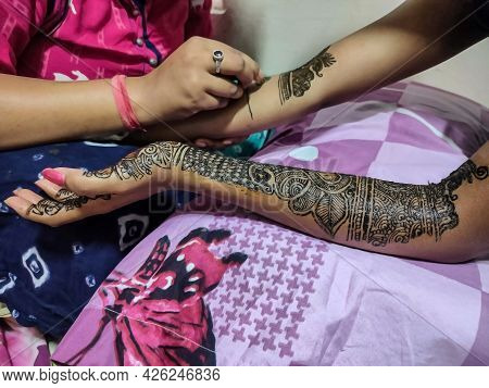 Stock Photo Of Henna Artist Applying Or Drawing Henna Design On Hand Of Bride With Piping Cone For T