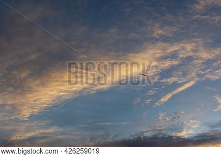 Eagle Sky Beautiful Clouds. A Black Silhouette Of A Bird Of Prey Soaring Among The Clouds. The Conce