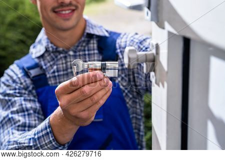 Locksmith Lock Door Repair. Worker Changing And Cylinder