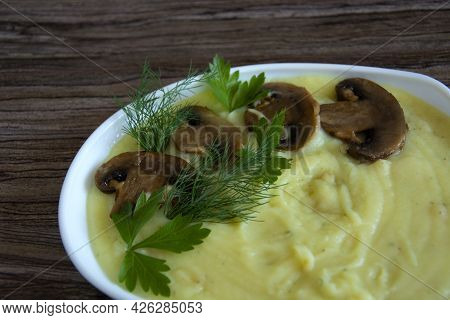Mashed Potatoes. A Garnish Of Champignon Mushrooms With Mashed Potatoes Are In A White Heart-shaped 