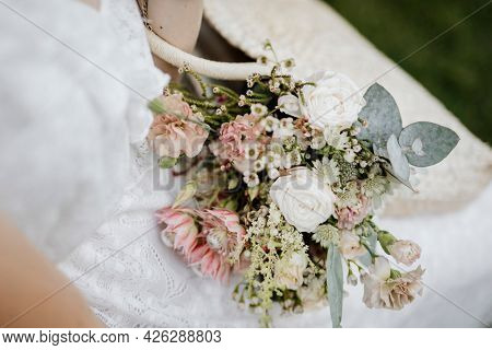 Woman with a woven bag full of flowers
