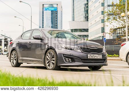 Moscow, Russia - May 2021: Kia K5 Is Driving Along The Street In City With Blurred Background. Side 