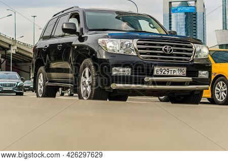 Moscow, Russia - May 2021: Toyota Land Cruiser 200 Is Driving In The Cityscape. Front Side View Of B