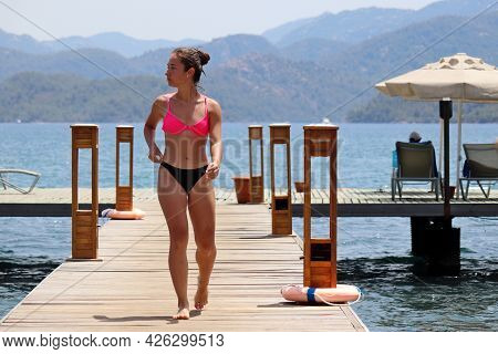 Hisaronu, Turkey - July 2021: Girl In Bikini Walking By Wooden Pier After Swimming In A Sea On Mount