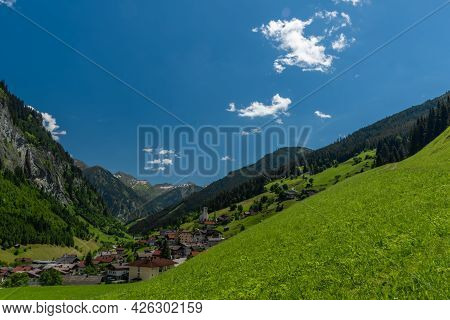 Summer Valley With Grossarler Ache Small River And Blue Cloudy Sky