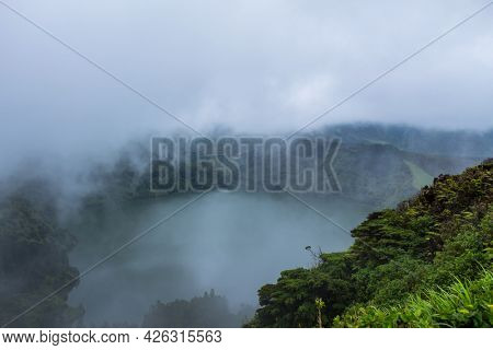Deep lake in Flores Island, Azores Archipelago, Portugal. Green lagoon with green vegetation