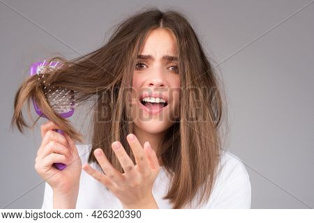Straightening Woman And Treatment Of The Hair. Girl With Straight Brushed Hair. Hair Tangling Proble