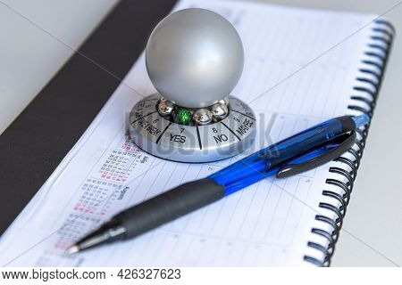 Table With Organizer, Pen And Wheel Of Opportunity, Pointer On Yes, Accidental Luck Concept