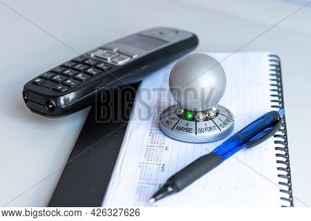 Table With Organizer, Pen, Phone And Wheel Of Opportunity, Pointer On Maybe, Accidental Luck Concept