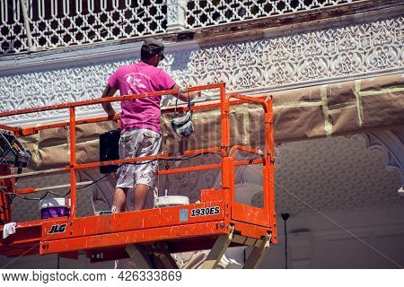 Torrevieja, Spain, 12.05.2021, Builder Doing Reconstraction Of Building, Painting Work