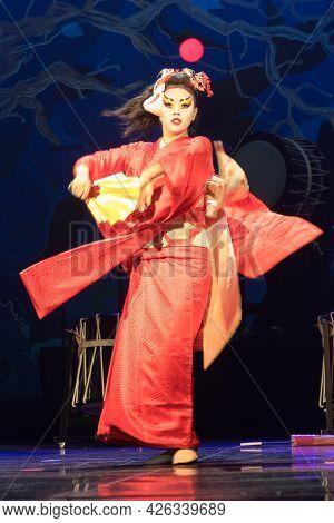 Woman Dances With A Fan. Traditional Japanese Performance Red Fox Dance. Kino Kitsune Fox Is A Chara