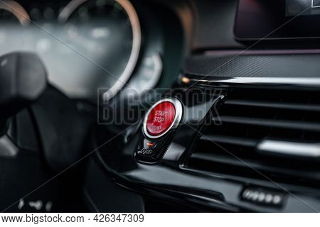 Sports Car Dashboard With Focus On Red Engine Start Stop Button. Button Engine Start And Engine Stop