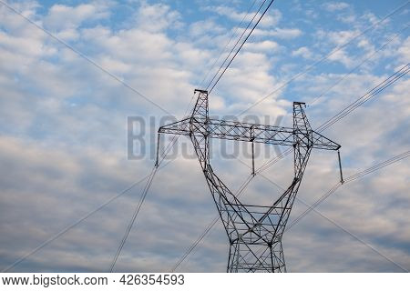 Metal Poles Electric Supports For High-voltage Wires In The Fields In The Summer.high Voltage Poles 