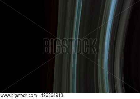Abstract Background Of Gray-green-blue Arcuate Lines On A Black Background.