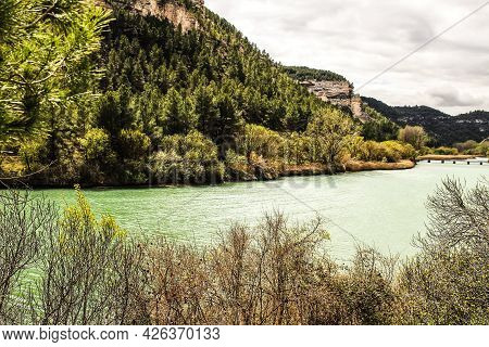 Tolosa Reservoir Surrounded By Vegetation And Mountains In Alcala Del Jucar Village, Albacete, Spain