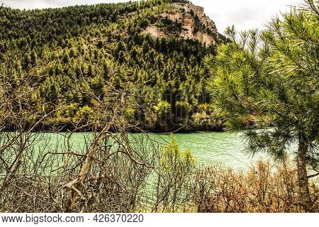Tolosa Reservoir Surrounded By Vegetation And Mountains In Alcala Del Jucar Village, Albacete, Spain