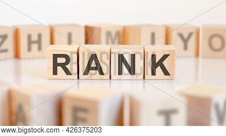 Rank Word From Wooden Blocks With Letters, Rank Or Doing Business Concept, Random Letters Around, Wh