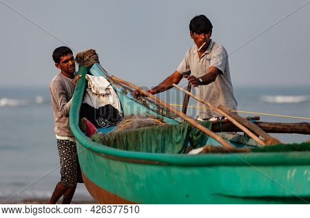 Morjim, North Goa, India , 29 March 2016 Fishermen Pull The Boat Ashore