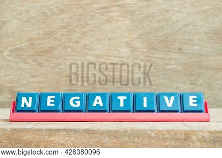 Tile Alphabet Letter With Word Negative In Red Color Rack On Wood Background