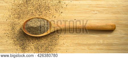 Aromatic And Fresh Powdered Black Pepper Ground, In Spoon On Wooden Bamboo Cutting Board