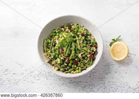 Traditional Middle Eastern Or Arabic Tabbouleh Salad Of Bulgur, Tomatoes, Asparagus, Green Peas And 