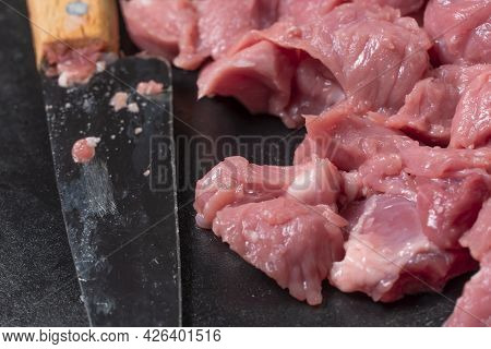 Slice The Pork Or Beef With A Knife On The Table In Close-up.preparation Of Meat Dishes And Food Pro