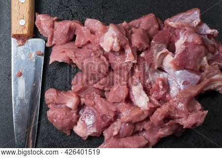 Slice The Pork Or Beef With A Knife On The Table In Close-up.preparation Of Meat Dishes And Food Pro