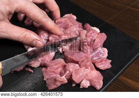Slice The Pork Or Beef With A Knife On The Table In Close-up.preparation Of Meat Dishes And Food Pro