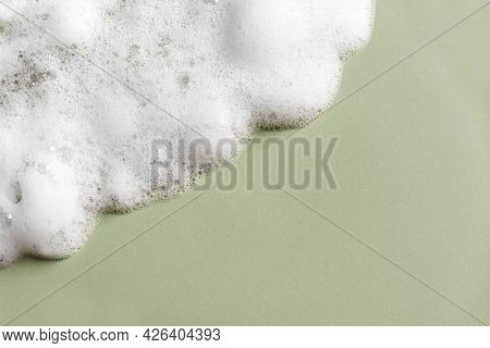 Face Cleansing Mousse Sample. White Cleanser Foam Bubbles On Green Background, Copy Space. Soap, Sho