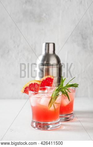Grapefruit Summer Coctail Grink With Slice Of Grapefruit And Rosemary On White Background, Copy Spac